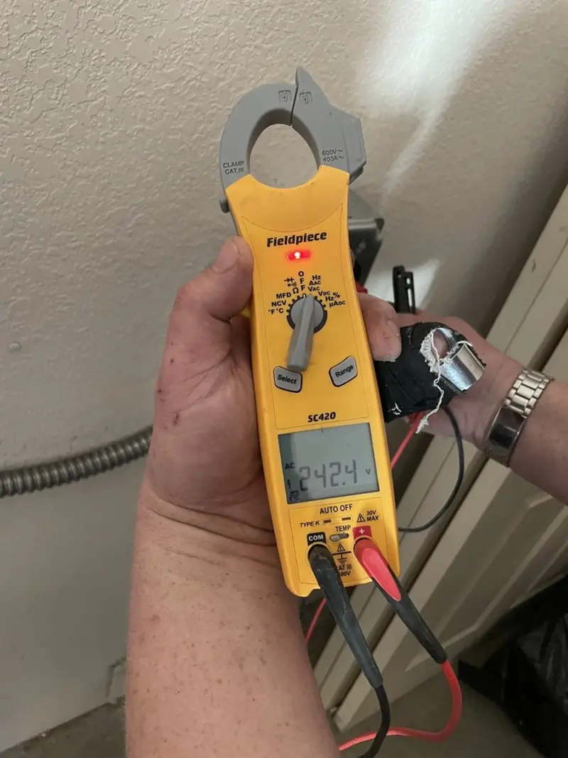Voltage testing with clamp meter during Recessed Lighting Installation in Munford